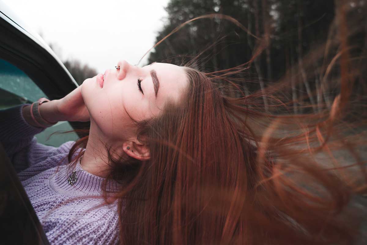 Woman with her head out a window