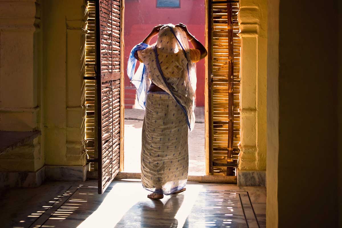 indian woman walking out a door