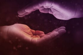 two glowing hands facing each other