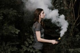 woman in the woods with smoke