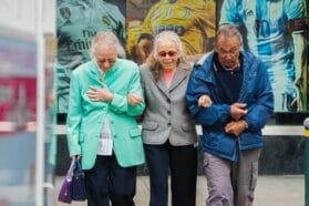 Three friends walking side by side