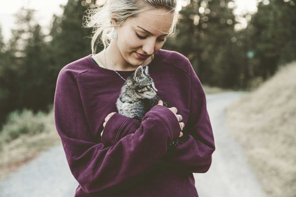young woman holding a cat