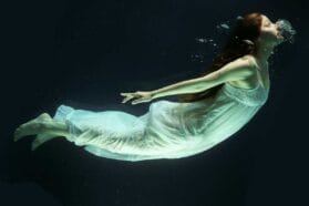 woman floating in a white dress