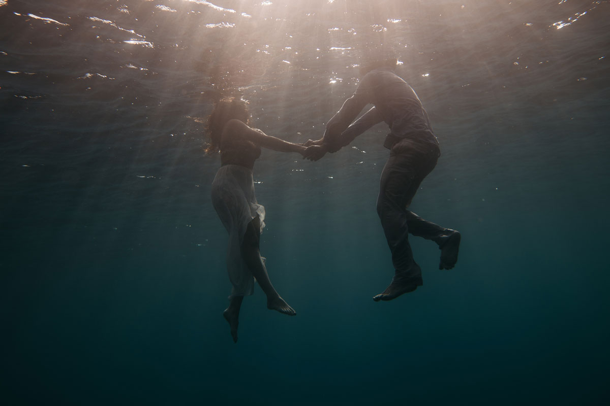 two people floating in the ocean