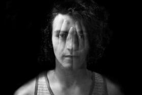 man with hands over his face