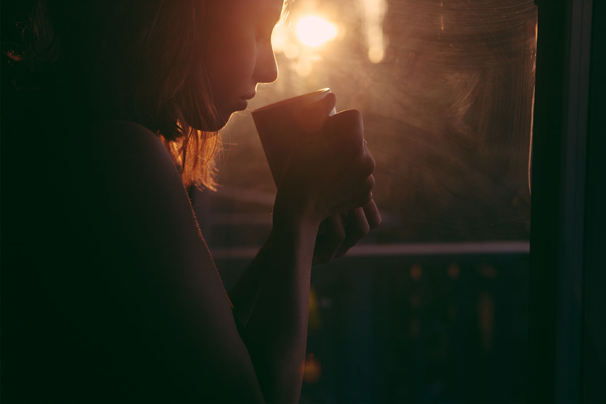 woman drinking tea, looking forlorn